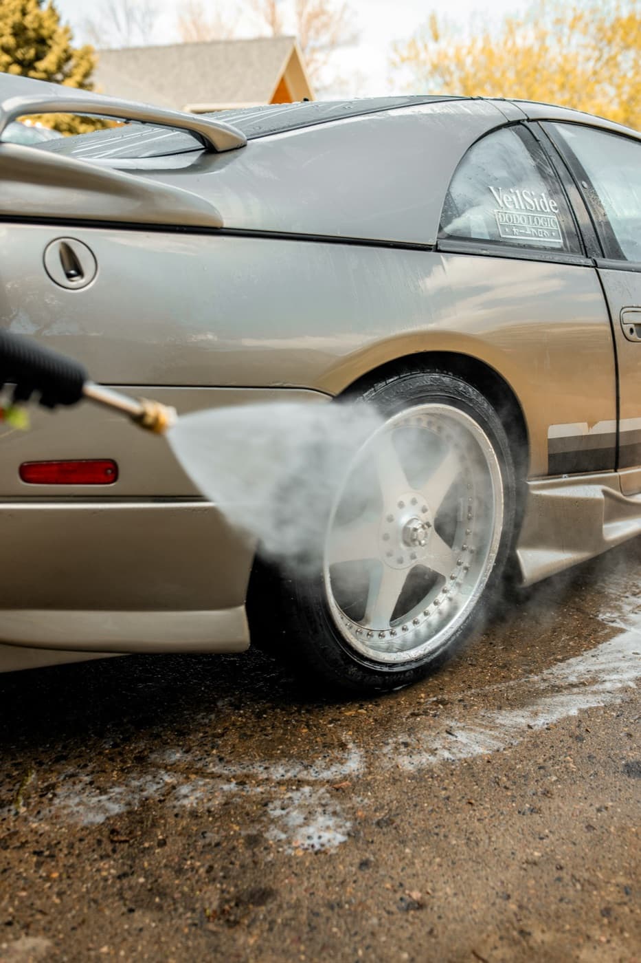 Pressure washer cleaning a car wheel